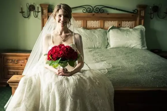 Veil or Not to Veil? 12 Bride sitting holding a bouquet of roses